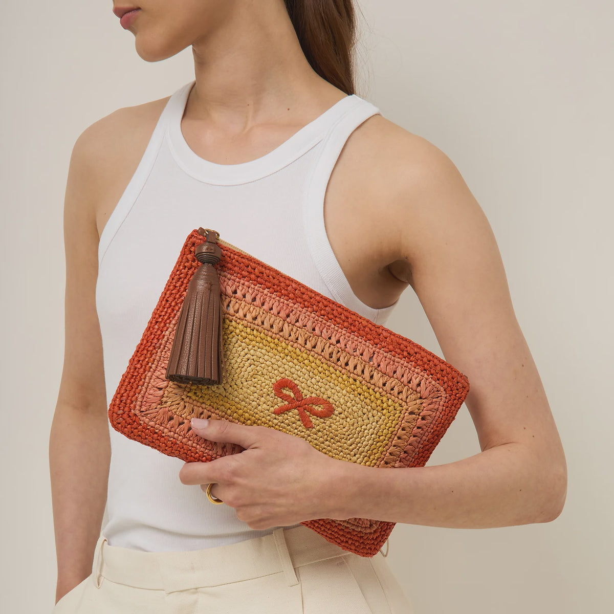 Anya Hindmarch Tassel Bow Clutch in Orange Multi Raffia