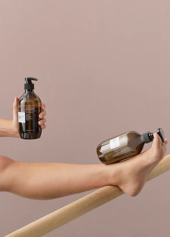 Brown bottle with pump labeled 'Ashley & Co' on a light gray background