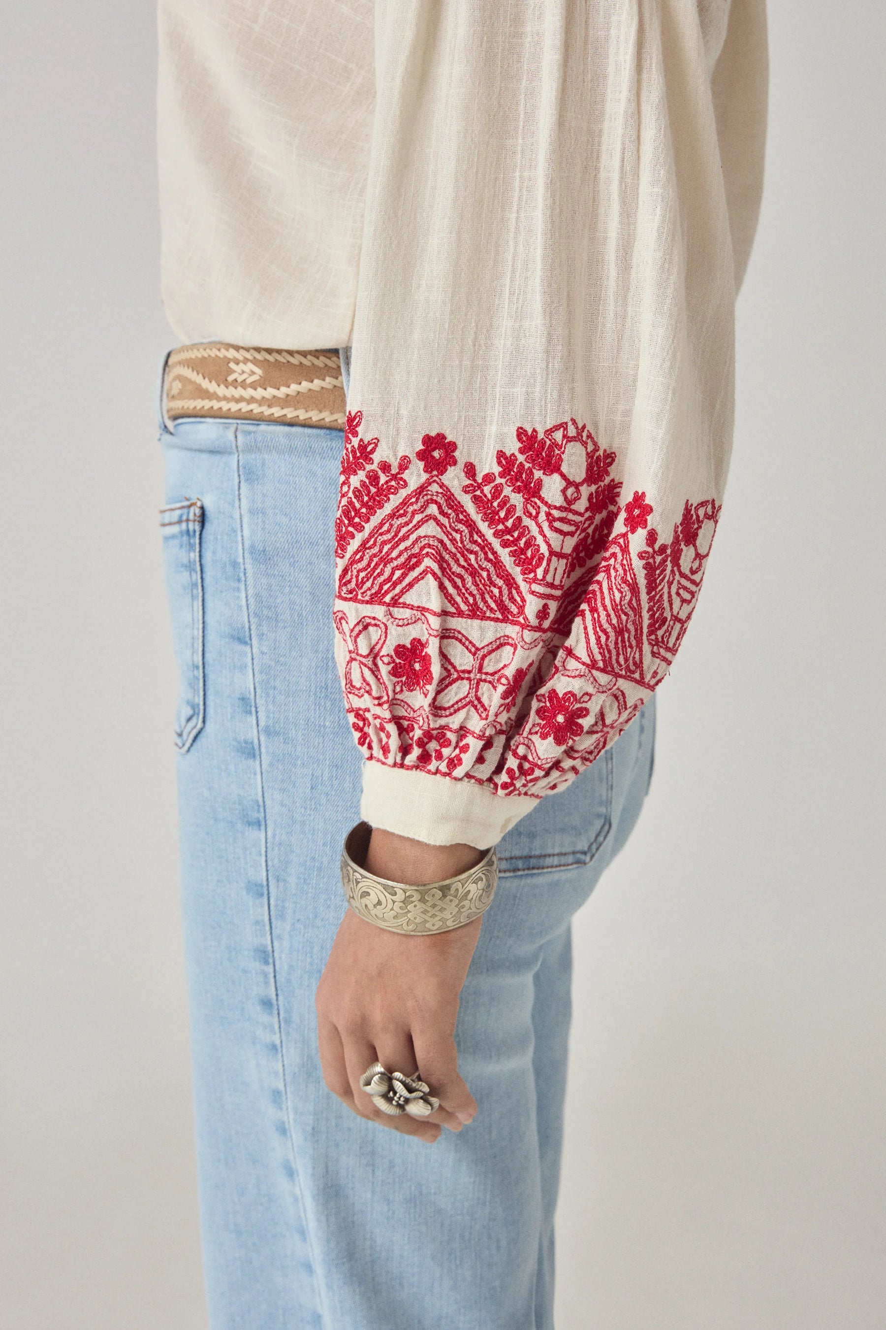 Maison Hotel Antonella Blouse Red Poppy in Cranberry is a beautifully embroidered cotton blouse inspired by traditional Ukrainian styles.