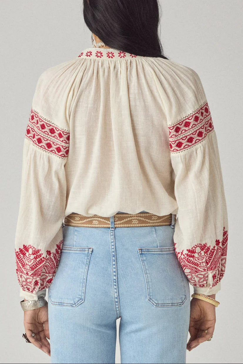 Maison Hotel Antonella Blouse Red Poppy in Cranberry is a beautifully embroidered cotton blouse inspired by traditional Ukrainian styles.