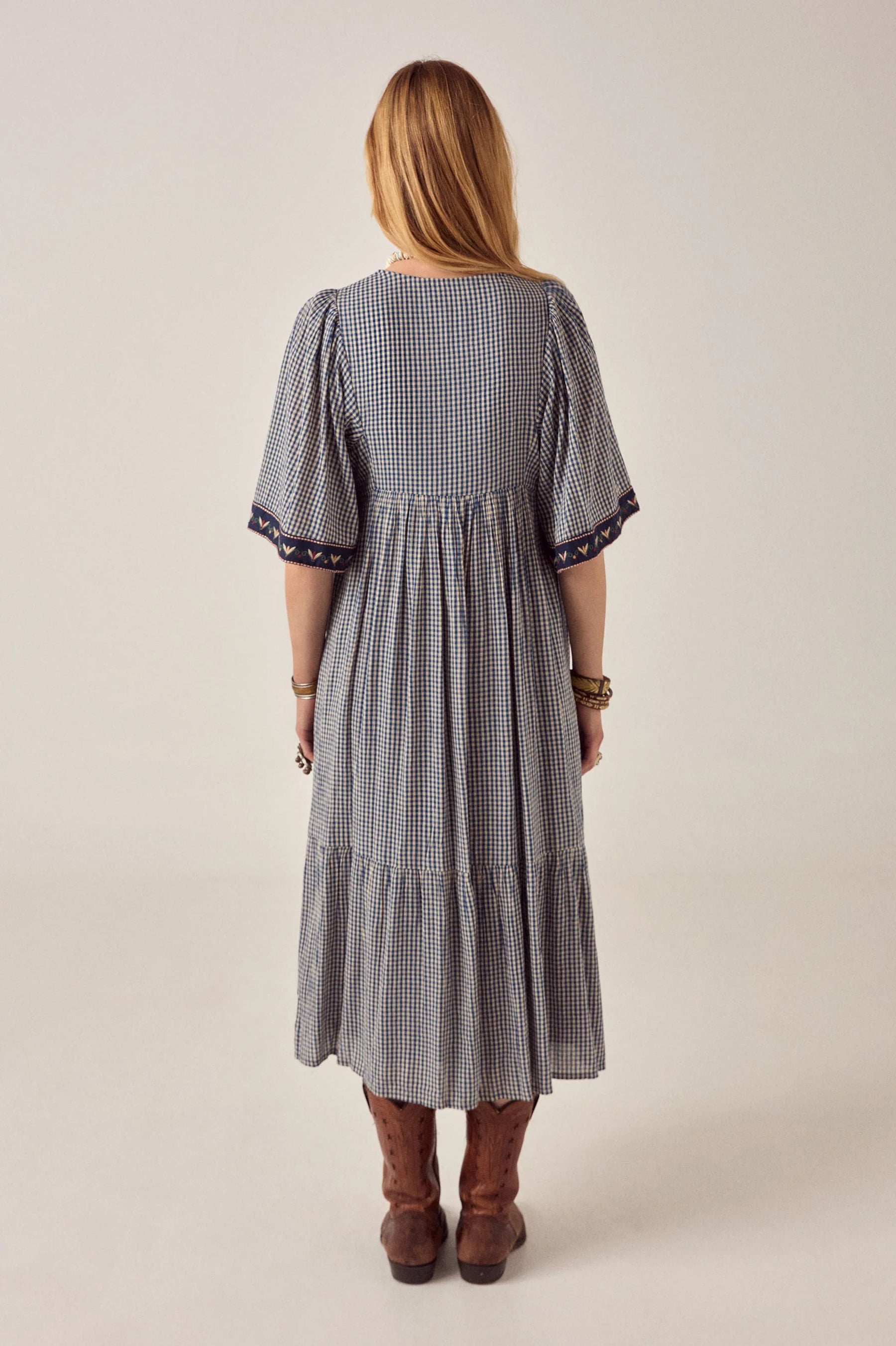 Maison Hotel Augusta Gingham Bloom Dress in Picnic Blue is a midi cotton gingham dress with statement embroidery.