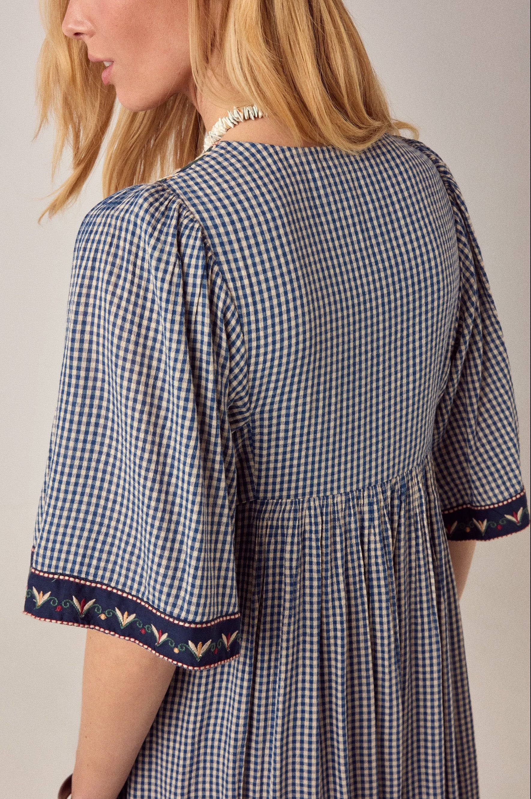 Maison Hotel Augusta Gingham Bloom Dress in Picnic Blue is a midi cotton gingham dress with statement embroidery.