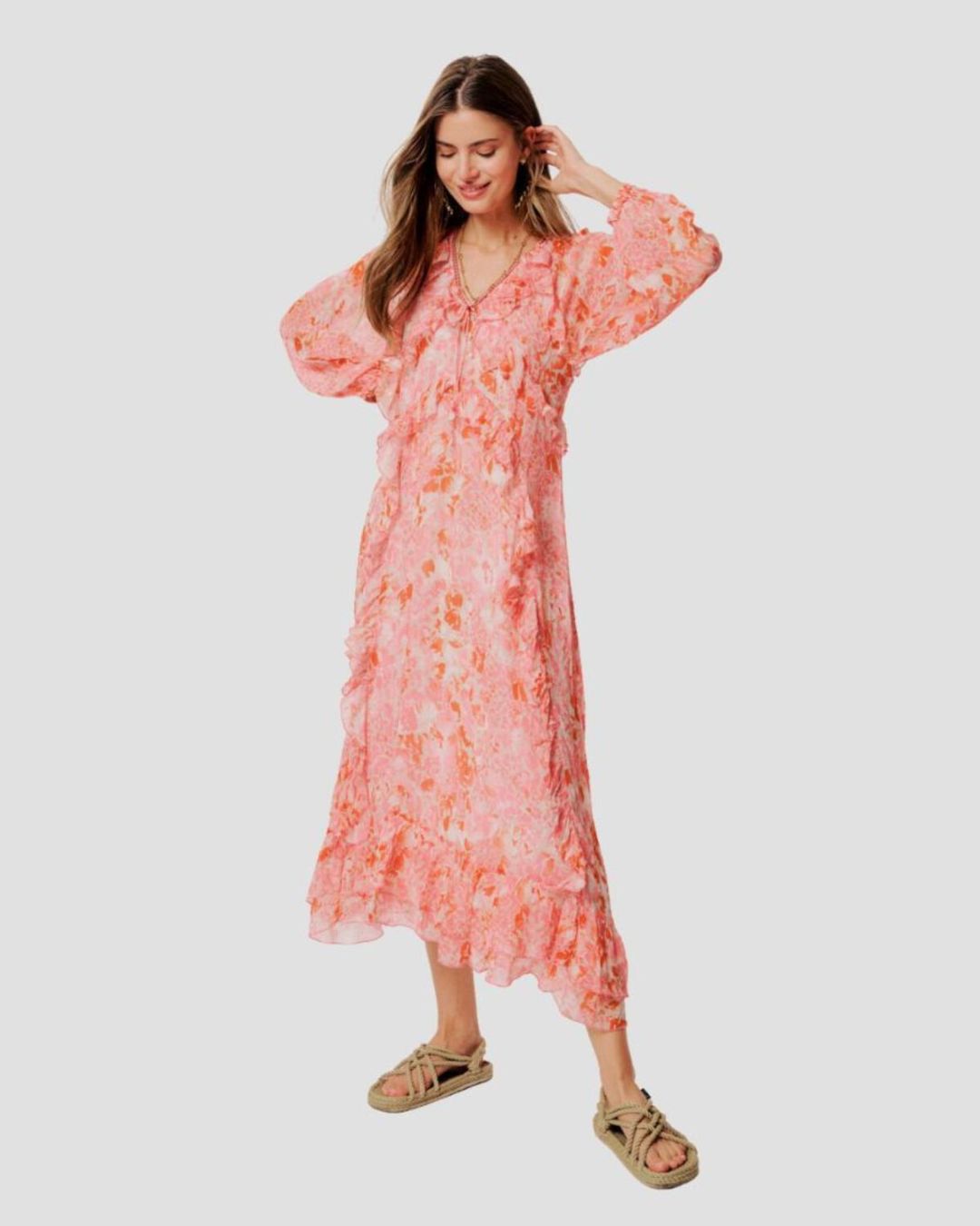 Woman wearing a pink floral dress on a white background