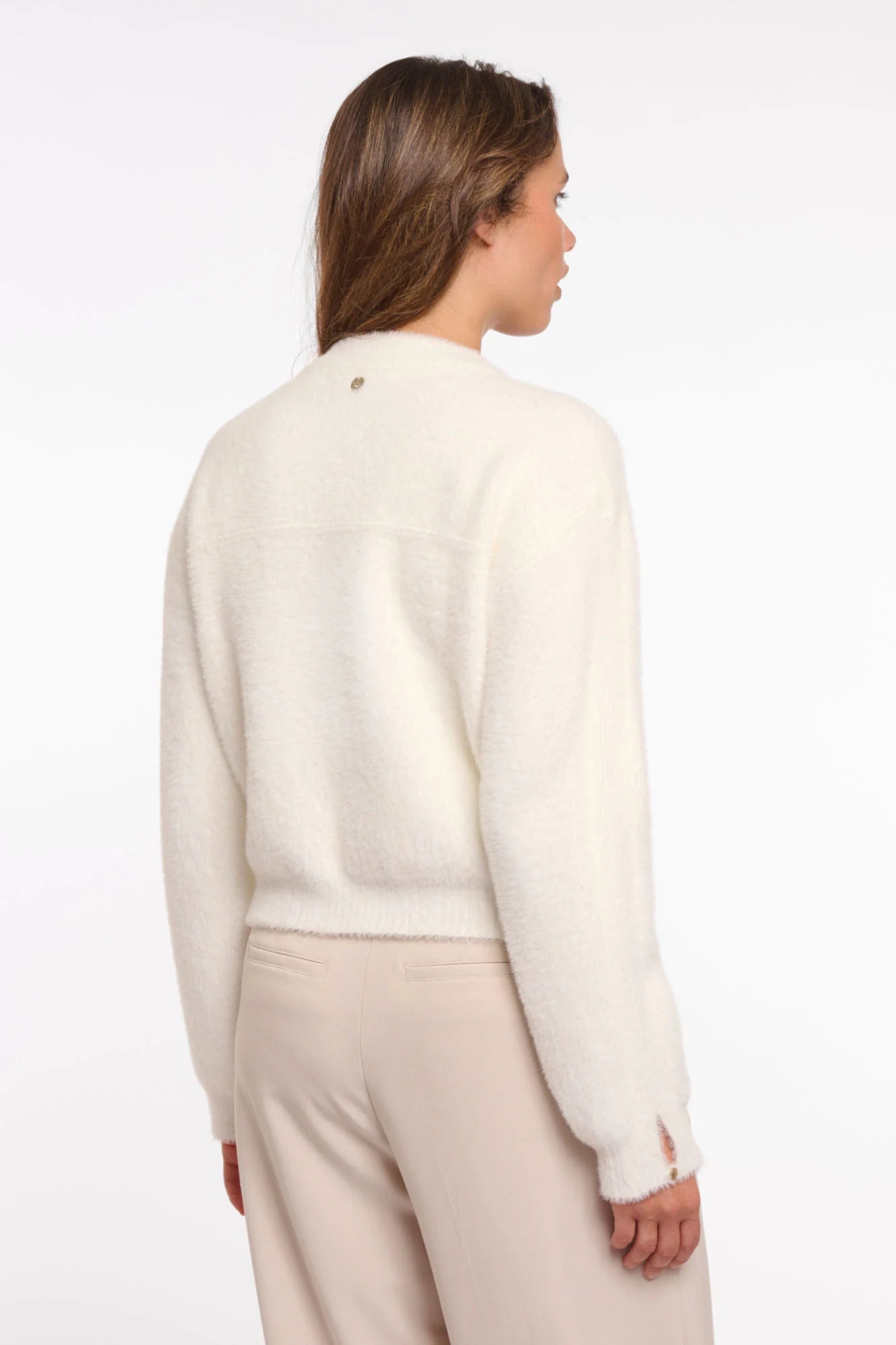 Rino & Pelle Bento Cardi in Snow White Woman wearing a cream sweater and beige pants on a white background